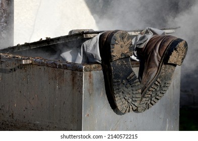 Repair Piping With Hot Water Steam In Hatch Of Device. Only Shoes And Feet Look Out Of Tank. Smoke Rolls In Winds Which Rolls Fog, Dust. Stainless Steel Kitchen Equipment Washes Inside Men, Film, Army