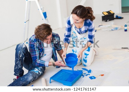 Repair, renovation and people concept - Close up portrait of couple pour paint