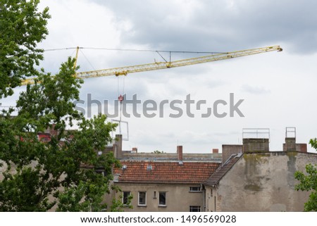 Repair restoration work in an old house in Berlin, crane with window frame