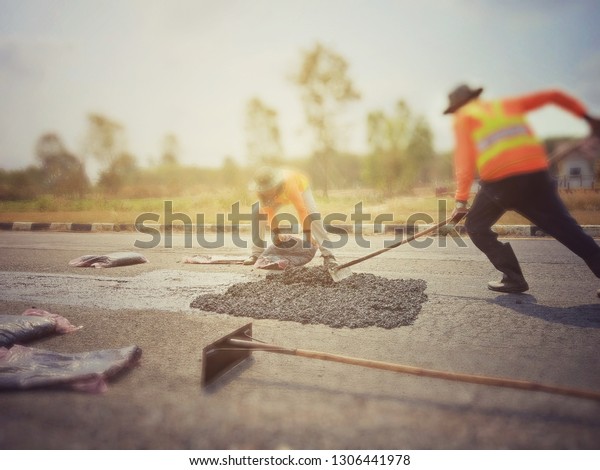 Repair of road maintenance by using asphaltic
concrete, photo blurred