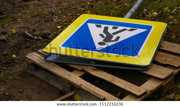 repair of a road\
sign pedestrian crossing. Broken pedestrian sign. Installation and\
repair of road signs