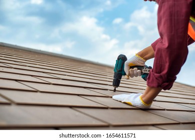 Repair The Roof With A Repairman Fixing Bolts And Tools, Roof Replacement.