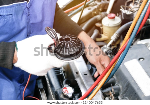 Repair Service Air Car\
System : The car mechanic checks the details of the key points of\
the hose connection to the pressure hose using the flashlight in an\
invisible spot.
