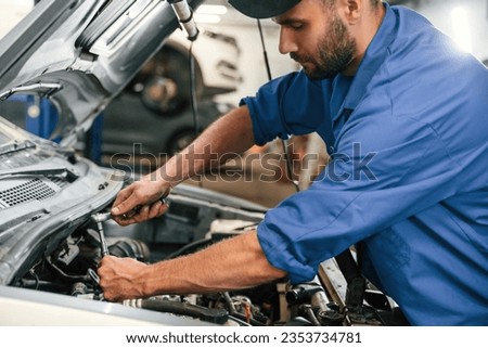 Repair service. Auto mechanic working in garage.