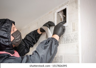 Repair Service Man Removing A Dirty Air Filter On A House So He Can Replace It With A New Clean. Extremely Dirty And Dusty White Plastic Ventilation Air Grille At Home Close Up, Harmful For Health