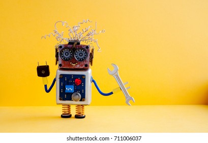 Repair Service Robot Handyman Hand Wrench. Creative Design Cyborg Toy, Electric Wires Hairstyle, Big Eye Glasses, Electronic Circuit Body, Red Heart. Yellow Background. Copy Space