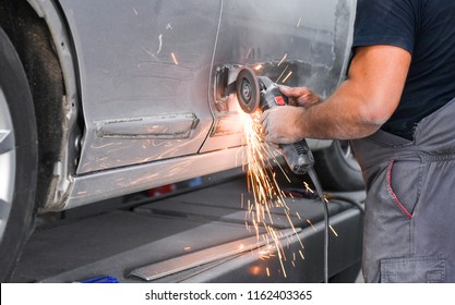 Repair service worker fix damaged car. Working with angle grinder to fix metal body. - Powered by Shutterstock