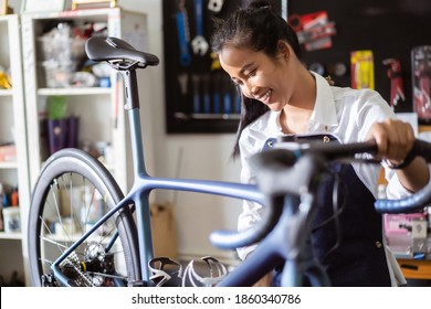 Repair technician woman bicycles was repaired gear bike shop. - Powered by Shutterstock