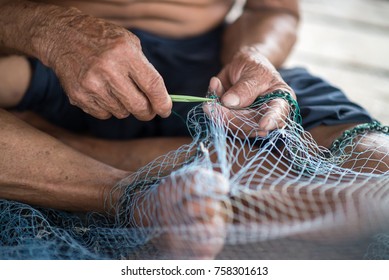 Repair traditional fishing nets.
