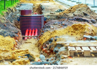 Repair Of Water Supply Networks. Red Plastic Pipes Are Connected To The Well.