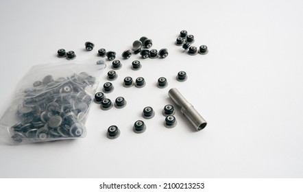 Repair Of Winter Studded Tires. Repaired Spikes Scattered On A White Background. Replaced Lost Tire Spikes.