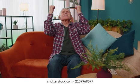 Repair work at neighbours. Irritated senior man sit on sofa cover ears with hands annoyed by noisy neighbors suffers from headache wishes silence. Thin walls at home, flat without sound insulation