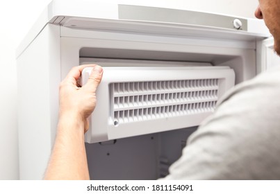 The repairer is fixing the freezer at home - Shutterstock ID 1811154091