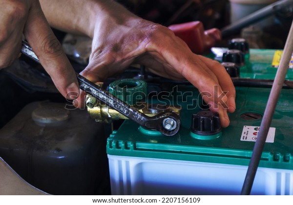 Repairing the battery by a technician from\
the service center. Service shop Battery\
repair