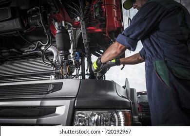 Repairing Broken Semi Truck Tractor Engine. Caucasian Trucks Mechanic. 