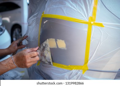 Repairing Car Body By Puttying Close Up Work After The Accident By Working Sanding Primer Before Painting. , The Mechanic Repair The Car  , Using Plastic Putty ,Prepare Surface For Spray Painting