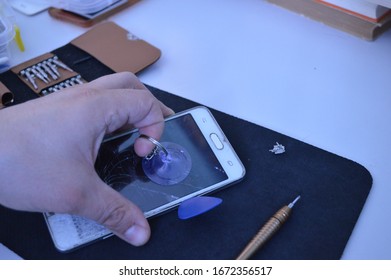 Repairing The Cell Phone By Vacuum Sucker Tool To Remove A Broken Screen