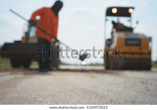 Repairing a damaged road For people to use the\
car to travel safely (blurred\
images)