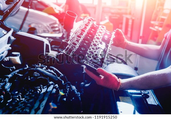 Repairing engine\
at service station. Car\
repair.