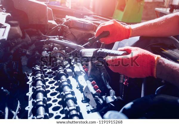Repairing engine\
at service station. Car\
repair.