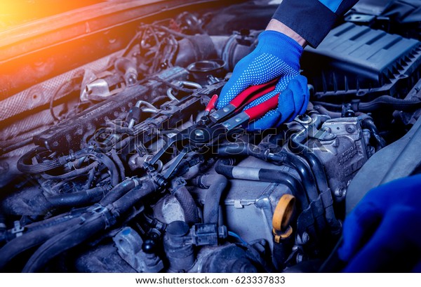 Repairing engine at service station. Car\
repair. Background