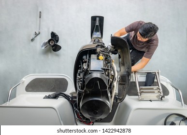 Repairing engines on aluminum boats , The technician is removing the boat parts to make the paint