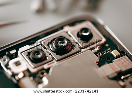 Repairing the mobile phone concept, camera repair. Close up at the lens.