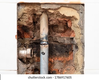 repairing of plumbing riser of heated towel rail at home - new pipe welded into water pipe and disconnected valve in wall of bathroom