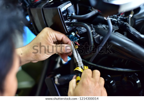 repairing power system of motorcycle, in motorcycle\
repair shop