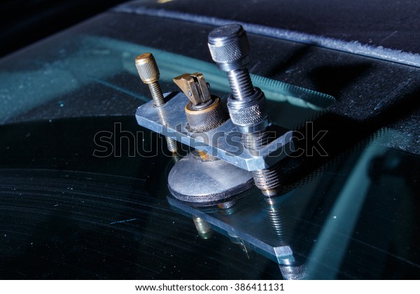 Repairing windshield on a car\
after stone-chipping damage/Car repair\
service/Transportation