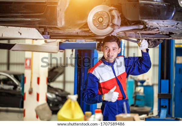 The repairman is checking the car for\
maintenance. Damaged engines undergo maintenance by expert\
technicians. Auto Service\
Concept