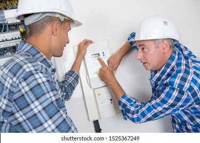 A Repairman Engineer Checking Thermostat