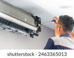 Repairman fix air conditioning systems, Male technicians service for repair and maintenance of air conditioners, Air conditioning technicians install new air conditioners in homes