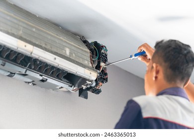 Repairman fix air conditioning systems, Male technicians service for repair and maintenance of air conditioners, Air conditioning technicians install new air conditioners in homes