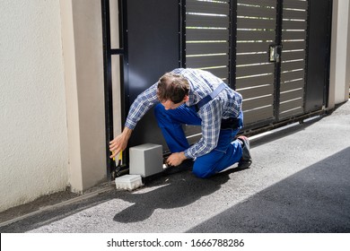 Repairman Fixing Broken Automatic Door In Building