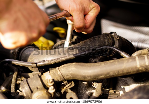 repairman is fixing the car\
engine