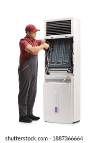 Repairman Fixing A Self Standing Portable Air Conditioning Unit Isolated On White Background