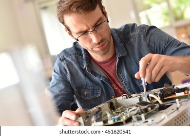 Repairman Fixing Tv Set