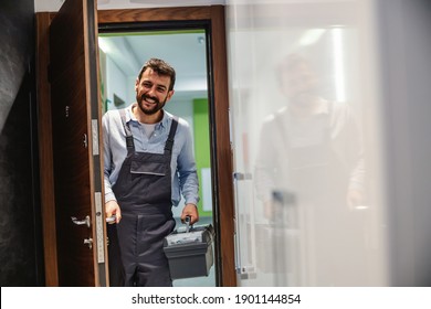 Repairman holding his box with tools and entering house. - Powered by Shutterstock