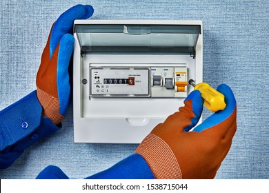 The Repairman Installed A New Electrical Panel In The House With An Electronic Electric Meter And Automatic Fuses, Or Circuit Breakers. Repair Of Household Power Systems, Electricity Wiring Service.