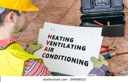 Repairman Is Looking At Documentation Of HVAC (Heating, Ventilating, Air Conditioning).