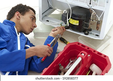 Repairman Makes Refrigerator Appliance Troubleshooting And Maintenance Works 