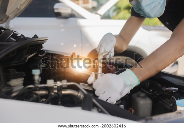 Repairman\
mechanic fixing a car with a socket\
wrench