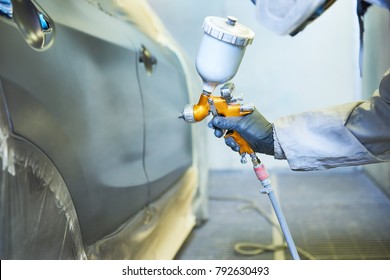 repairman painter in chamber painting automobile car bonnet - Powered by Shutterstock