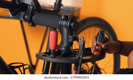 Repairman preparing work tools before starting mending broken customer bicycle, studio background, expert arranging mechanical gear, ready to start servicing bike.