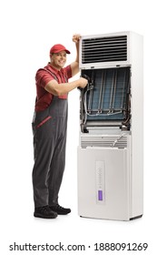 Repairman Repairing A Self Standing Portable Air Conditioning Unit Isolated On White Background