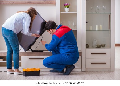 Repairman Repairing Tv At Home