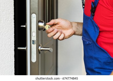 Repairman Working With House Door Lock