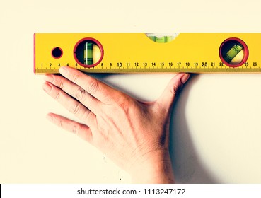 Repairman working with measuring ruller on the wall