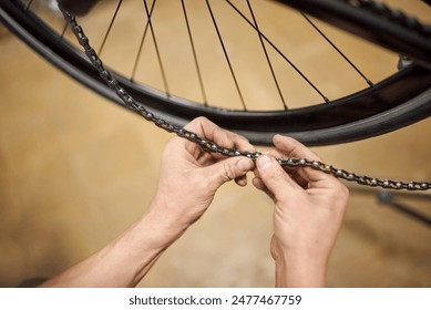 Repairman working: unrecognizable man locking the chain of a bicycle in his bike workshop. Real people at work. Close up view of the hands. - Powered by Shutterstock